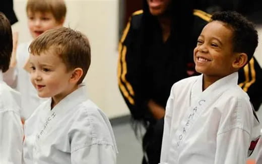 a group of children in white shirts