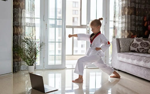 a young girl in a karate uniform