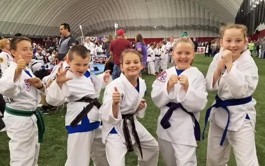 a group of girls in karate uniforms