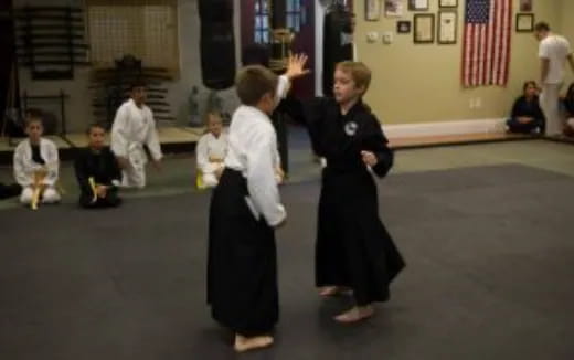 a person and a boy in a karate uniform