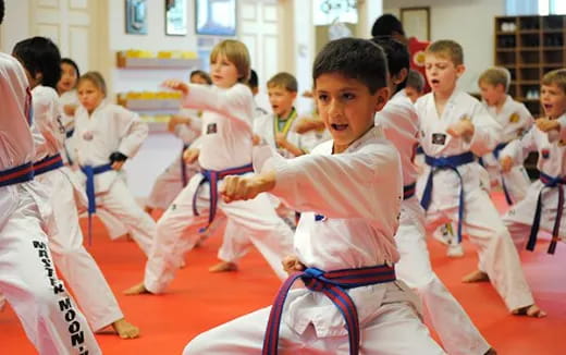 a group of children in karate uniforms