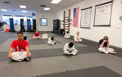 a group of people sitting on the floor in a room