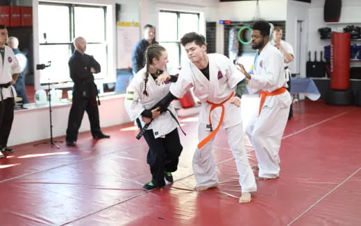 a group of people in karate uniforms