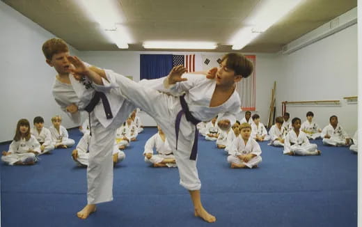 a man and a woman practicing karate