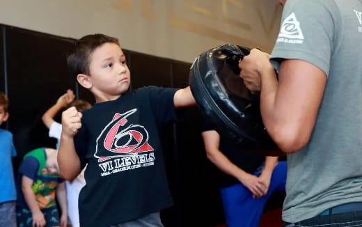 a boy holding a baseball hat