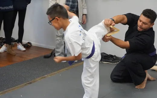 a man doing a plank with another man