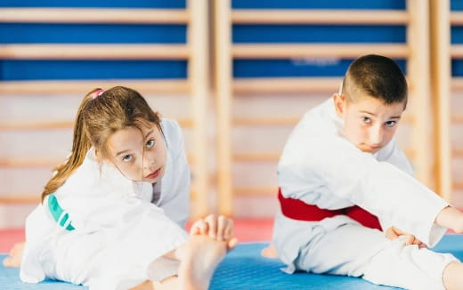 a boy and girl sitting on the floor