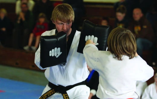 a man and woman in karate uniforms