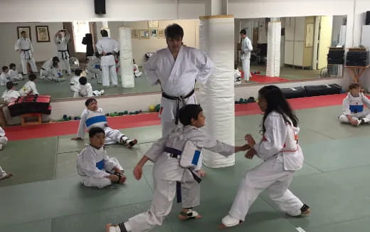 a group of people in karate uniforms