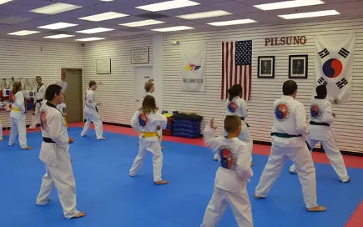 a group of people in karate uniforms