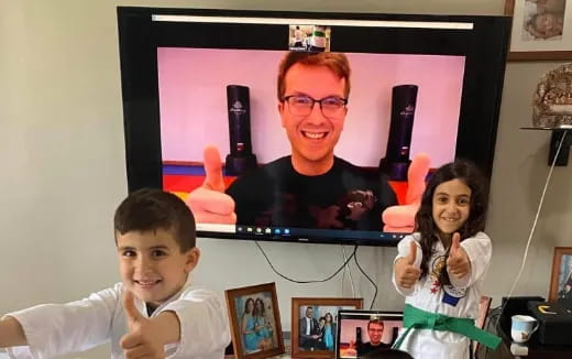 a person and two children in front of a television