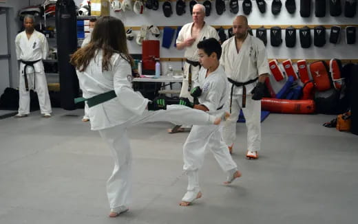 a group of people in karate uniforms