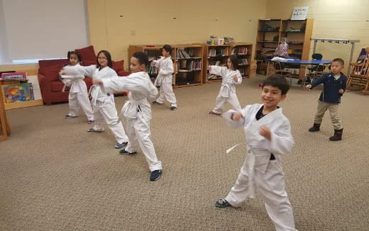 a group of children in karate uniforms