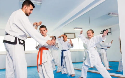 a group of people in karate uniforms