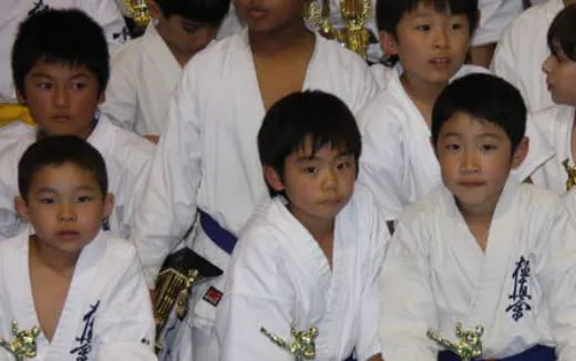 a group of boys in white robes