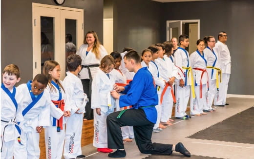 a group of people in karate uniforms