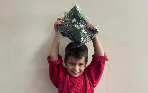 a boy holding a bag of money