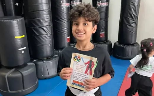 a boy holding a piece of paper