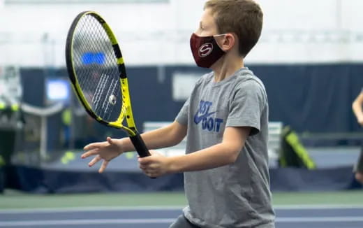 a boy playing tennis