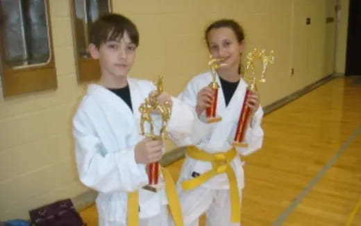 two boys holding trophies