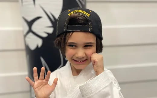 a girl wearing a black hat and holding a pen