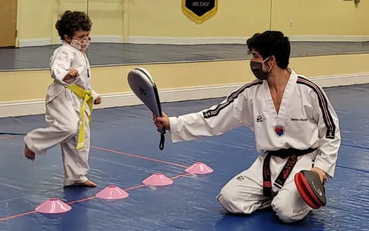 a couple of people in karate uniforms