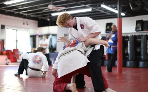 a person kicking another man in the face