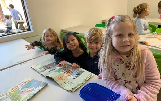 a group of children sitting at a table