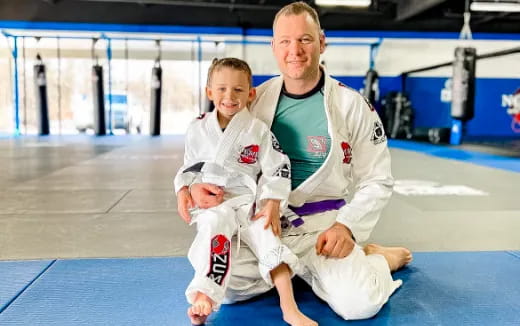 a person and a boy in karate uniforms