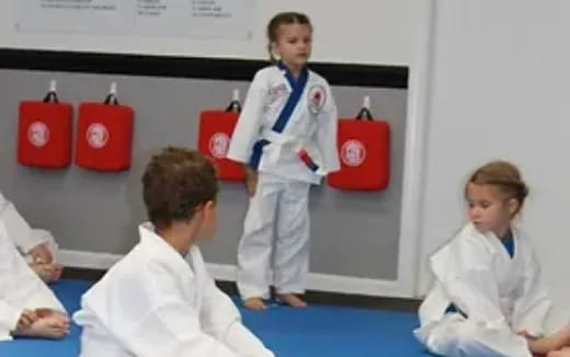 a group of people in white lab coats and red gloves
