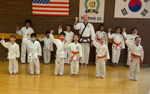 a group of children in karate uniforms