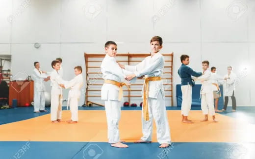 a group of people in karate uniforms