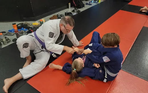 a man and two children on a mat