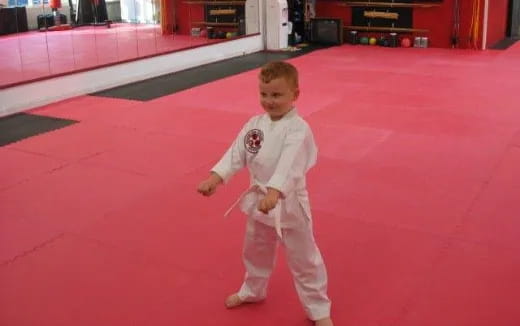 a boy in a karate uniform