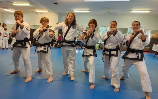 a group of people in karate uniforms