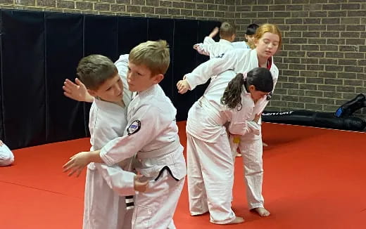 a group of children in karate uniforms