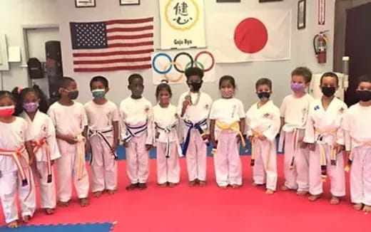 a group of children in karate uniforms