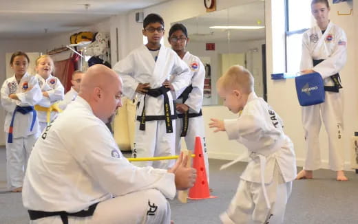 a group of people in white karate uniforms