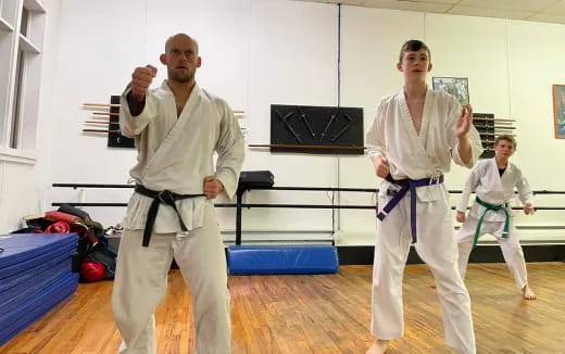 a group of people in karate uniforms