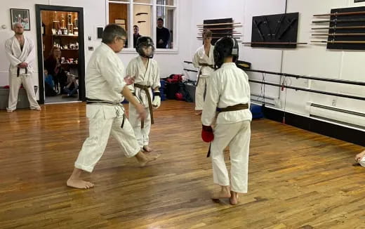 a group of people in white karate uniforms