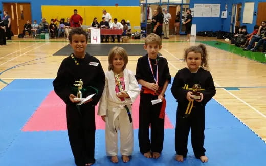 a group of children in karate uniforms