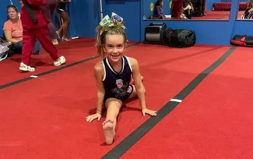 a person in a leotard on a mat