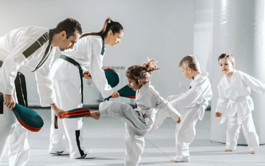 a group of people in karate uniforms