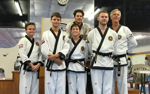 a group of men in karate uniforms