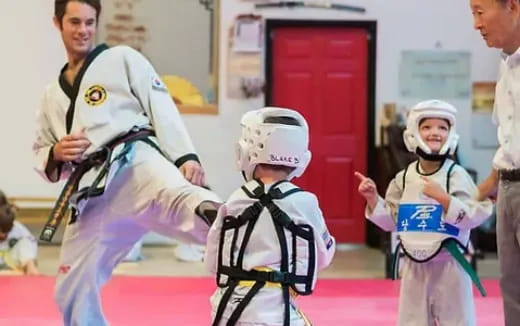 a group of people in white karate uniforms