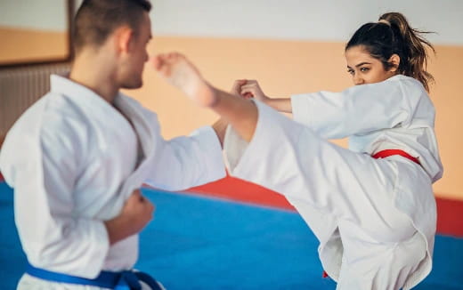 a man and a woman in karate uniforms