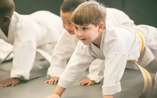 a young boy in white karate uniform