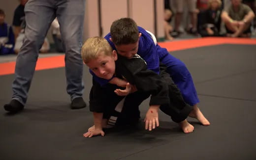 a person and a boy kneeling on the floor