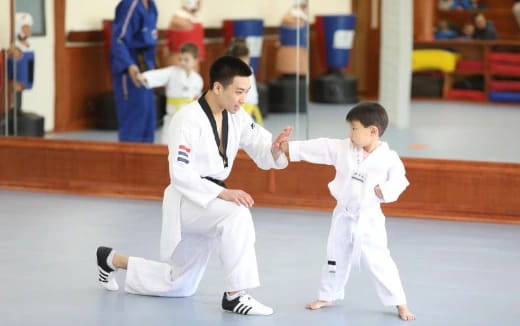 a couple of boys in karate uniforms