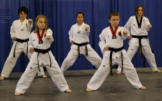 a group of people in karate uniforms